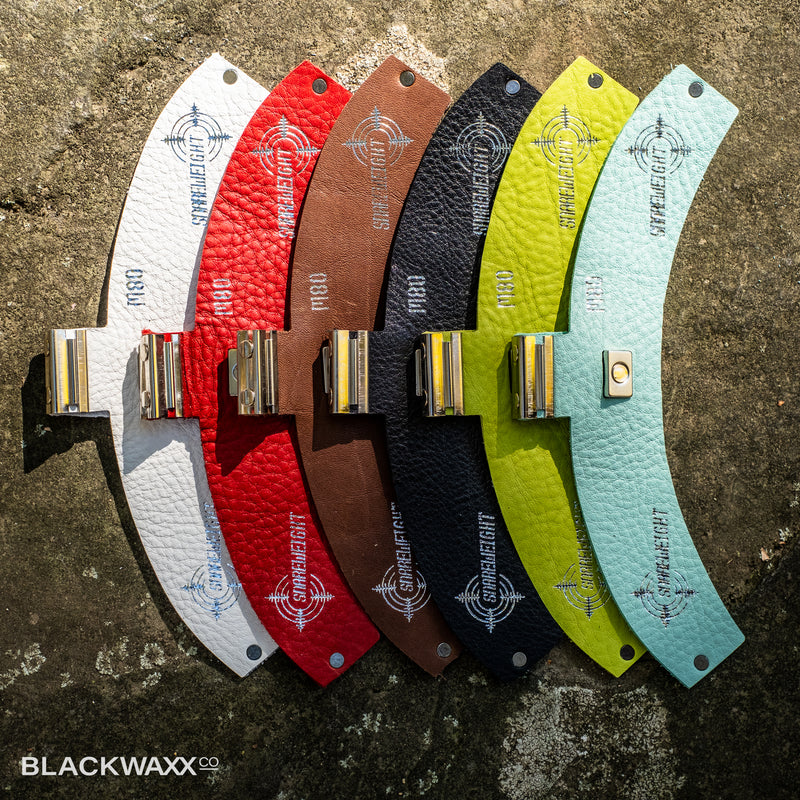 Snareweight M80 drum dampeners in all six colours: white, red, brown, black, wasabi green and sea foam green, fanned out side by side