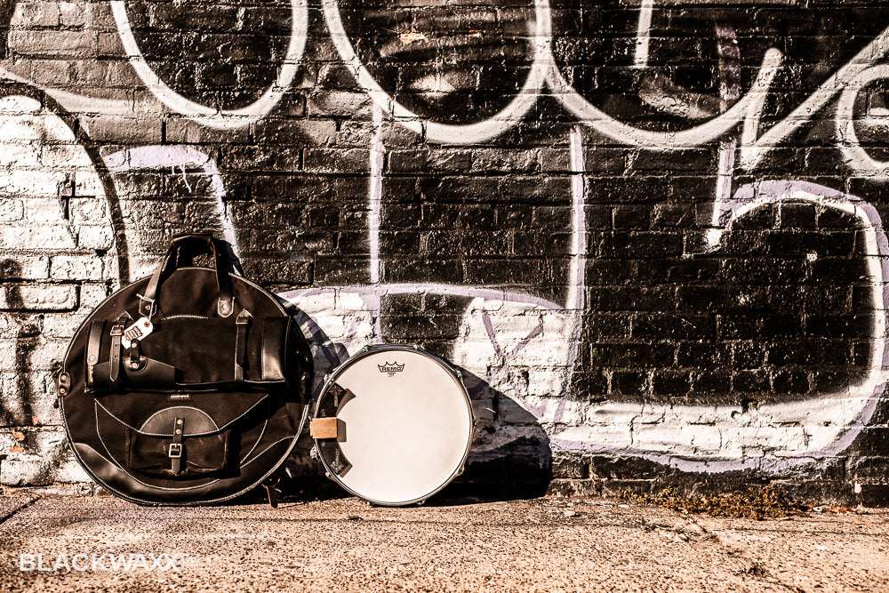 Drummer at a kit in low light